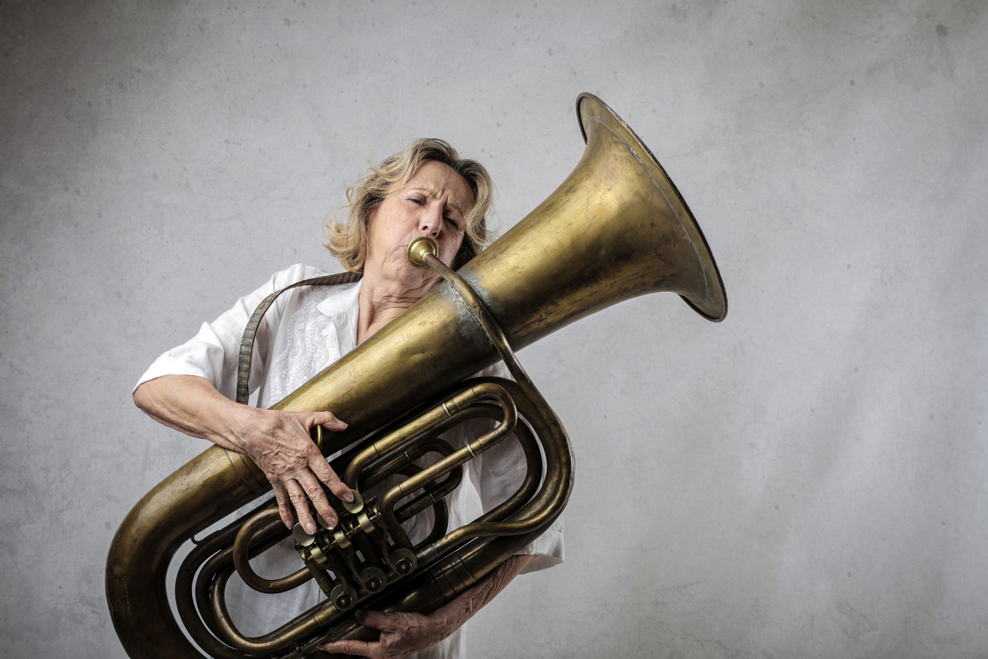 Senior woman playing the tuba